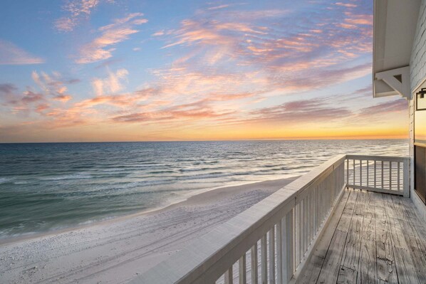A wooden deck overlooking a beach with a sunset view. - A Grand View – Stunning Gulf Views & Direct Beach Access (Santa Rosa Beach)