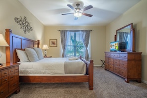 A bedroom with a bed, dresser, and ceiling fan. - Spacious 3BR/2BA Apartment at Vista Cay, Minutes from Disney & Universal (Orlando)