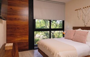 A bedroom with a large window, a bed with white bedding, and a wooden wall. - 3 Bungalow 3 Bedrooms | Swimming Pool + Private Jacuzzi (Tulum)