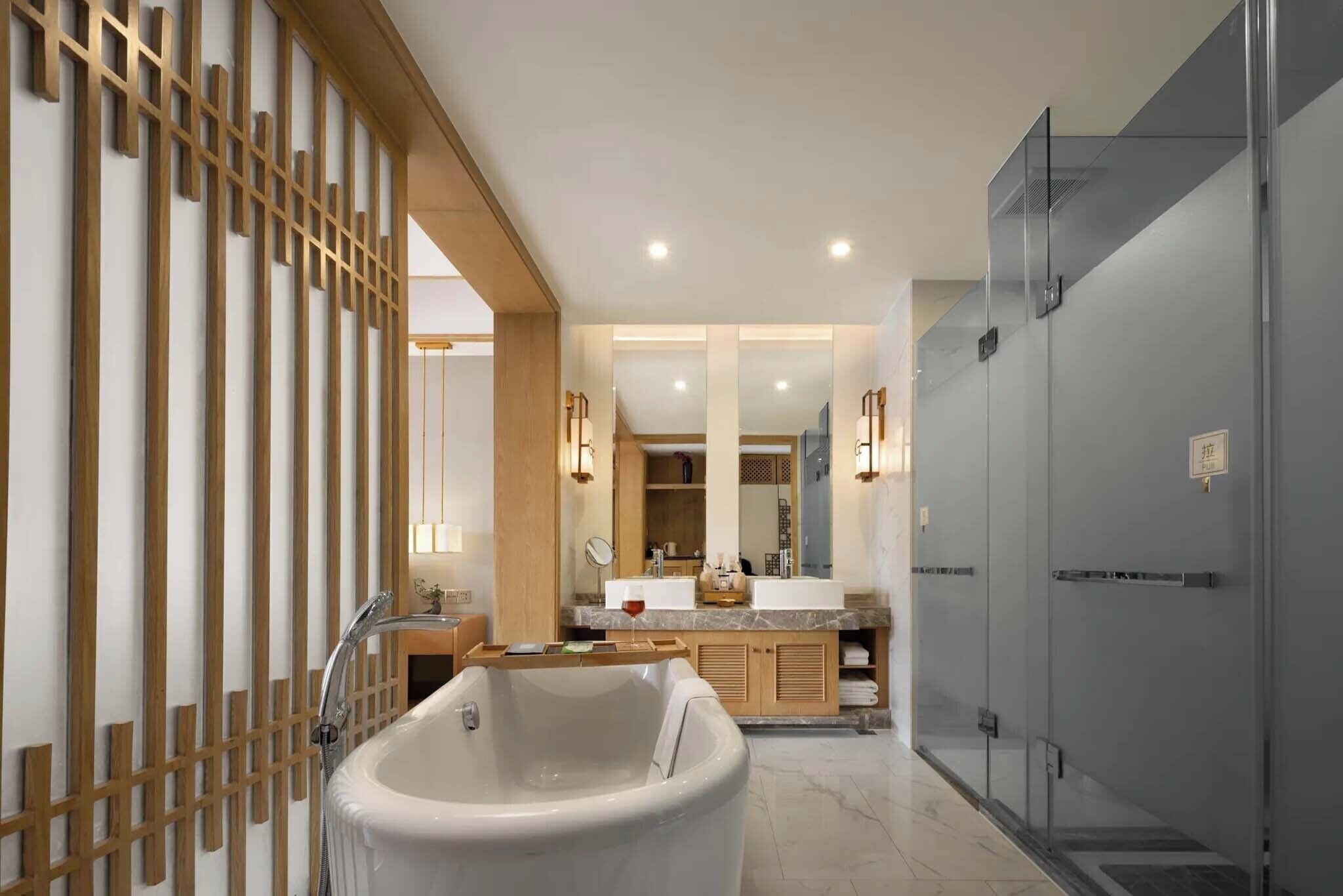 A modern bathroom with a freestanding bathtub, a vanity with a mirror, and a glass shower enclosure.
