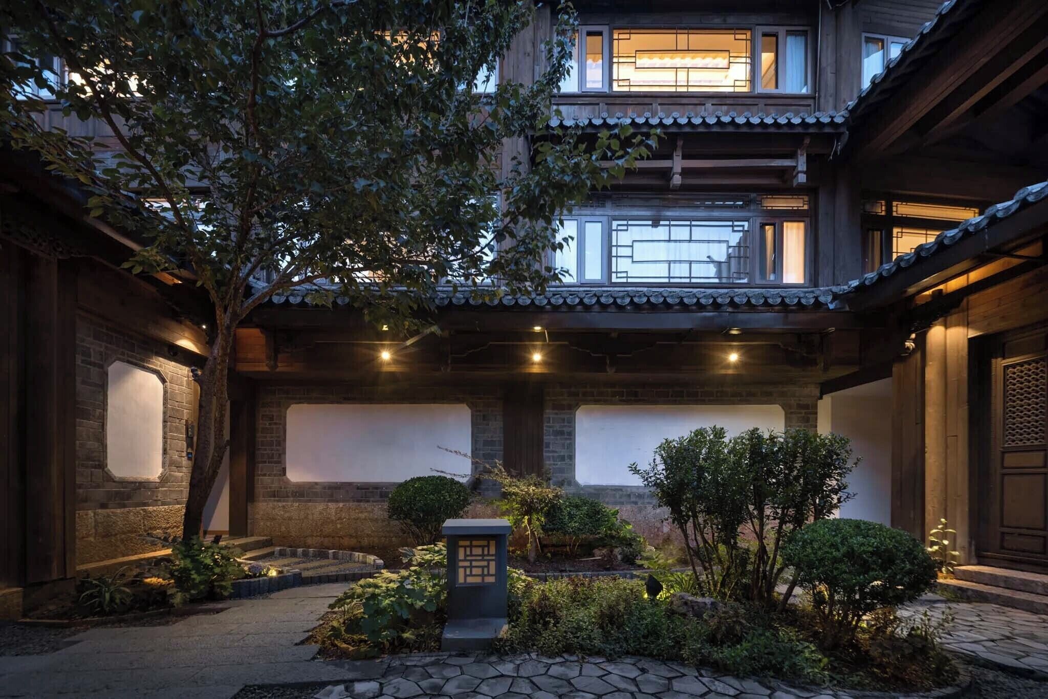 A traditional building with a courtyard, wooden beams, and tiled roofing.