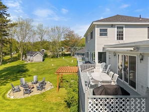 A residential property with a deck, outdoor seating, and a well-maintained lawn. - Private Oceanfront Oasis 4-bedroom house in Brooklin perfect for your getaway (Brooklin)