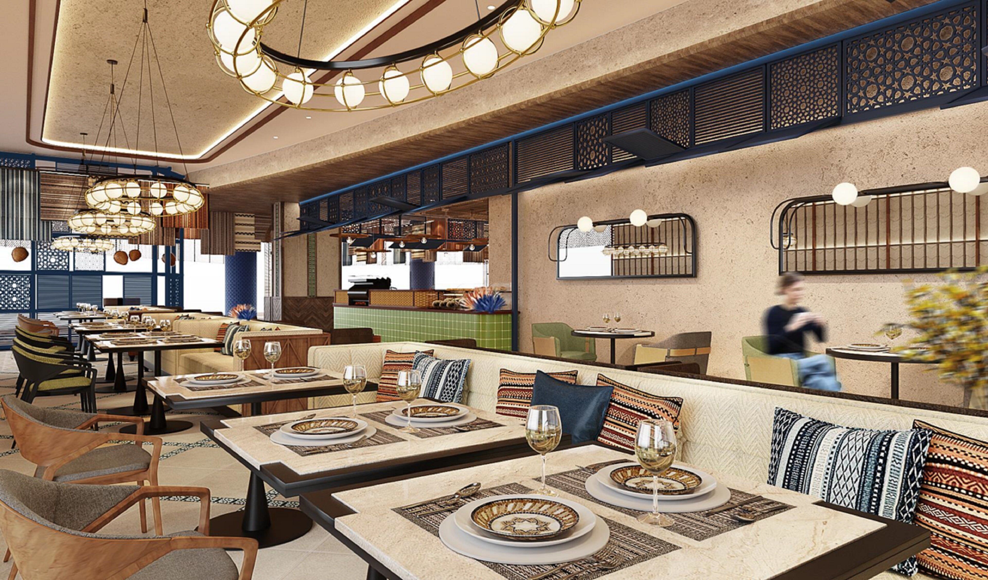 A restaurant interior with multiple dining tables, chairs, and a bar area.