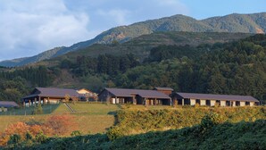 A row of buildings with flat roofs, surrounded by a hilly landscape. - AUBERGE de SENVIE (Sakurai)