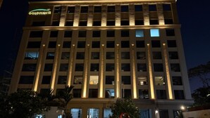 A multi-story hotel with a prominent 'GOLDFINCH' sign, large windows, and a symmetrical facade. - Goldfinch Panjim Goa (Panaji)