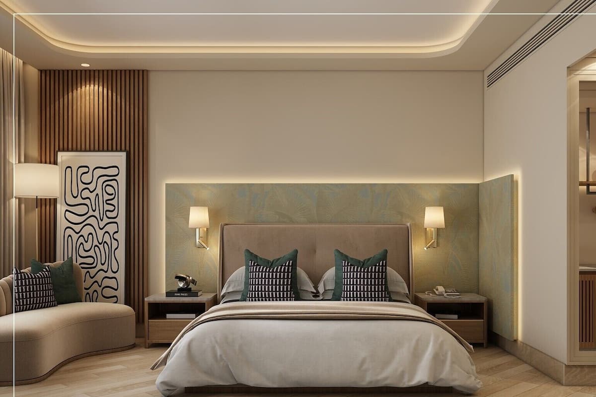 Una habitación de hotel moderna con una cama grande, dos mesitas de noche, un sofá y un adorno de pared.