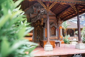 A traditional Balinese temple with ornate carvings and a tiled roof. - Pande Permai Guest House (Ubud)