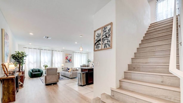 Ein geräumiger Wohnbereich mit einer Treppe, die in eine obere Etage führt.