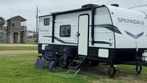 A white RV with 'SPRINGDALE' branding parked on grass. - Welcome to Cozy by the Coast! Just steps from the beach, ocean is calling you! (Surfside Beach)