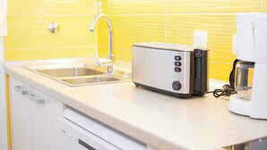 A kitchen with a stainless steel sink, a toaster, and a coffee maker on the countertop. - Holiday apartment mit Klimaanlage (Medulin)