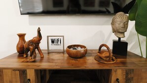 A wooden table with a vase, a bowl, a figurine, a framed sign, and a bust. - Private Pool Oasis • 10 Min to Westgate & State Farm Stadium (Phoenix)