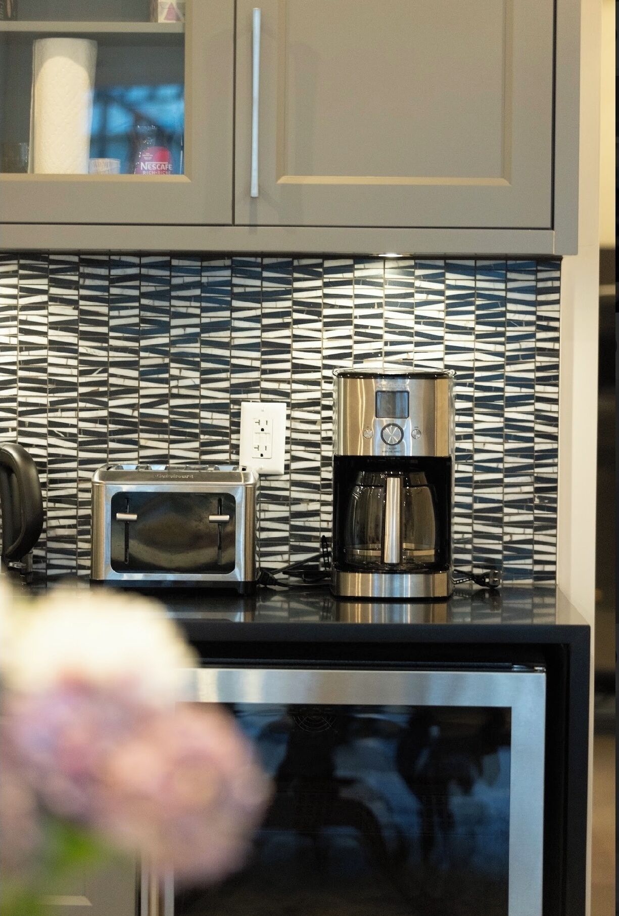 A kitchen with a toaster, coffee maker, and a microwave.