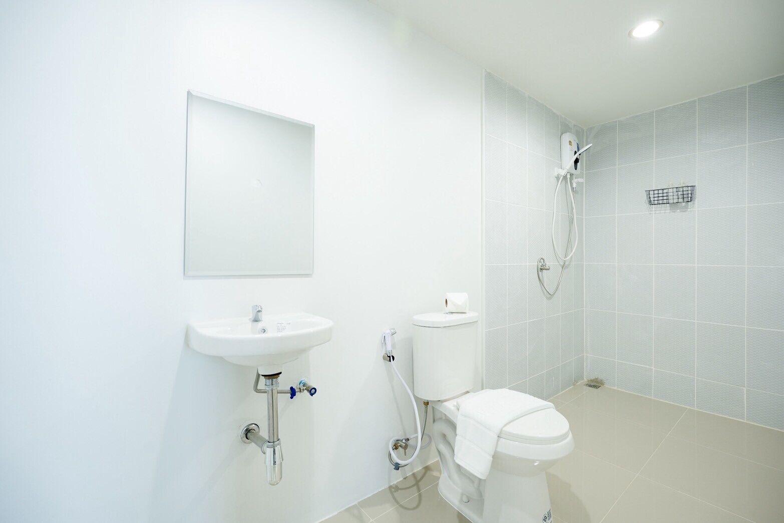 A bathroom with a sink, toilet, and shower.