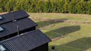 A rural landscape with a house featuring a sloped roof and solar panels. - Luxe Villa - Ocean Views, 15km to Coolum Beach (Ninderry)