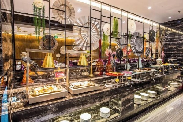 A buffet area with various food items and decorative elements. - Miramar Urumqi (CCMALL Hongshan Park Times Square Branch) (Urumqi)