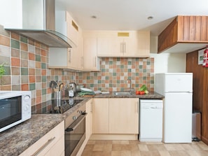 A kitchen with a microwave, oven, sink, and refrigerator. - Virginia Cottage - 28108 (Bovey Tracey)