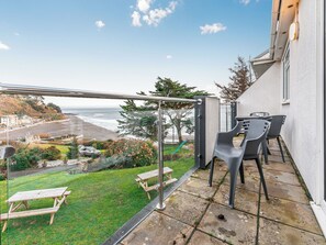 Outdoor dining - A first floor apartment with sea views from the balcony. (Seaton)