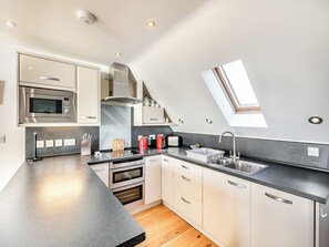 Private kitchen - A contemporary house in a peaceful setting, with superb views over the sea. (Seaton)