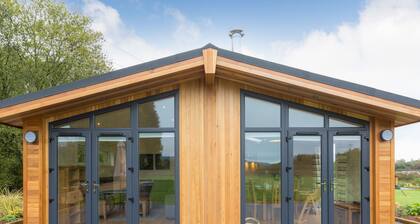 Escape from it all and enjoy a stylish lodge in a beautiful setting.