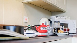 A kitchen with a kettle, a coffee maker, a microwave, and a toaster. - Mill Farm Cottages - Kingfisher (Barlow near Bakewell)