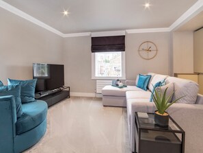 A modern living room with a sofa, a TV, and a coffee table. - A wonderful base to go off and explore the magical city of York. (York)