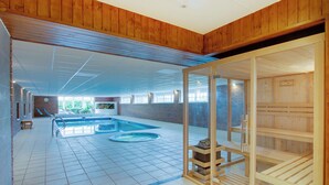 A spacious indoor swimming pool with multiple lanes, a sauna area, and a seating area with sun loungers. - 3 bedroom accommodation in Forfar (Forfar)