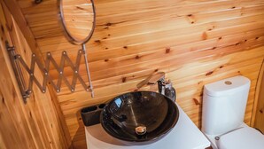 A wooden cabin bathroom with a black sink, a white toilet, and a mirror on the wall. - A perfect escape for couples and friends. (Stewarton)