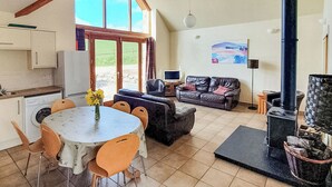 A spacious living area with a dining table, sofa, and a fireplace. - 3 bedroom accommodation in Lumphanan, near Banchory (Lumphanan, near Banchory)