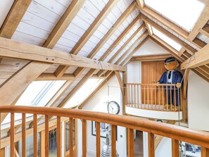 A wooden balcony with a clock and a teddy bear. - 4 bedroom accommodation in Bembridge (Bembridge)