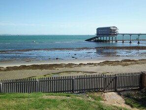 A coastal view with a wooden pier and a building on stilts. - 4 bedroom accommodation in Bembridge (Bembridge)
