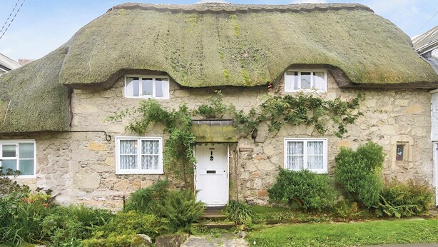 A stone house with a thatched roof, ivy-covered walls, and a small front porch. - 3 bedroom accommodation in Niton, near Ventnor (Niton, near Ventnor)