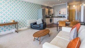 Ein modernes Wohnzimmer mit einer Couch, einem Couchtisch und einer Wand mit Muster.