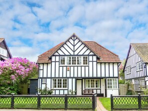 A traditional Tudor-style building with a symmetrical facade, a central entrance, and a small porch area. - 3 bedroom accommodation in Thorpeness, near Aldeburgh (Thorpeness, near Aldeburgh)
