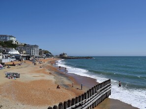 A beach with a wooden pier, buildings, and a lighthouse in the background. - 3 bedroom accommodation in Ventnor (Ventnor)