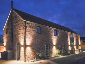 A brick building with a gabled roof, a small window, and a door. - Chestnut House - UKC4650 (Dunholme, near Lincoln)