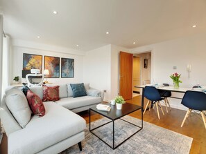 A modern living room with a sofa, coffee table, and dining area. - 2 bedroom accommodation in Newcastle Upon Tyne (Newcastle Upon Tyne)