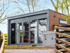 A modern building with large glass doors, a wooden exterior, and a metal roof. - The Foxes Den - UKC8196 (Rhayader and the Elan Valley)