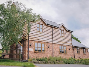 A two-story wooden building with a brick base, named 'Drover's Barn'.