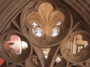 Ein Dominneres mit gotischen Bögen und Buntglasfenstern.