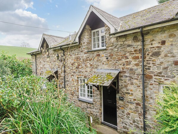 A stone house with a black door and a small porch. - Number Two - UKC4964 (Tawstock, near Barnstaple)