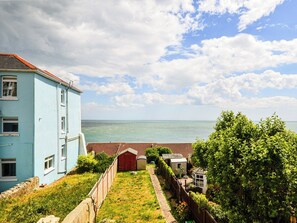 A coastal property with a light blue building, a fenced garden, and a view of the sea. - 3 bedroom accommodation in Ventnor (Ventnor)