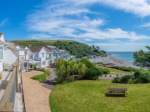 A coastal residential area with houses, a beach, and a grassy hill. - 11 Mount Brioni - UKC5345 (Torpoint)