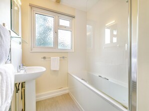 A bathroom with a white sink, a glass shower enclosure, and a window with frosted glass. - 11 Mount Brioni - UKC5345 (Torpoint)