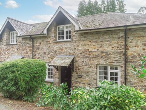 A stone building with a gabled roof, multiple windows, and a small porch. - Number Three - UKC4965 (Tawstock, near Barnstaple)