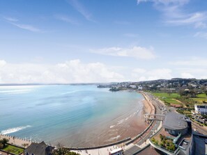 A coastal town with a beach, a promenade, and residential areas.