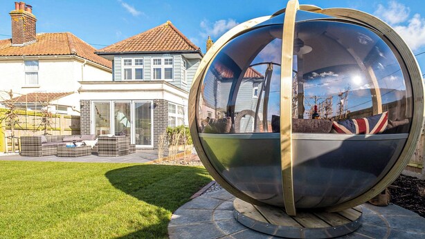 A spherical structure with a reflective surface, possibly a sculpture, in a landscaped outdoor area with a house in the background. - 2 bedroom accommodation in Aldeburgh (Aldeburgh)