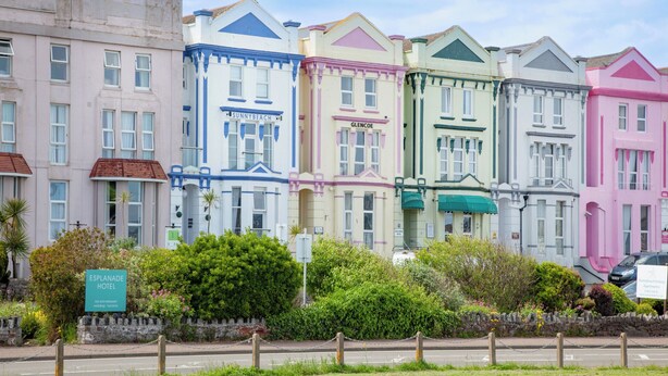 A row of colorful, historic buildings with signage for 'Sunnybeach' and 'Glencoe'. - Mermaids View - UKC6166 (Paignton)