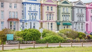 A row of colorful Victorian-style buildings with a sign for the Esplanade Hotel. - The Little Lobster - UKC6167 (Paignton)