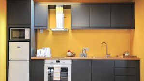 Eine moderne Küche mit Mikrowelle, Backofen und Spüle.