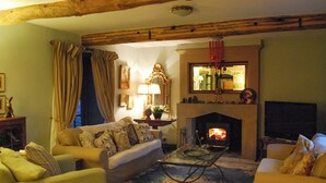 A cozy living room with a fireplace, a television, and comfortable seating. - 5 bedroom accommodation in Over Haddon, near Bakewell (Over Haddon, near Bakewell)